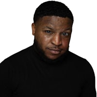 a black man with a beard posing for a photo