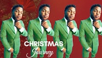 a man in a green suit is posing in front of a christmas tree
